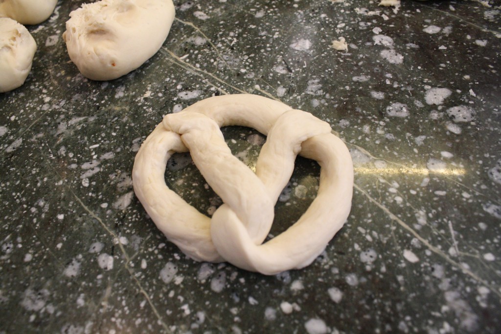 Step 4 of Pretzel Making: Bring the bottom ends of the loop up to join the edge of the top part of the circle.
