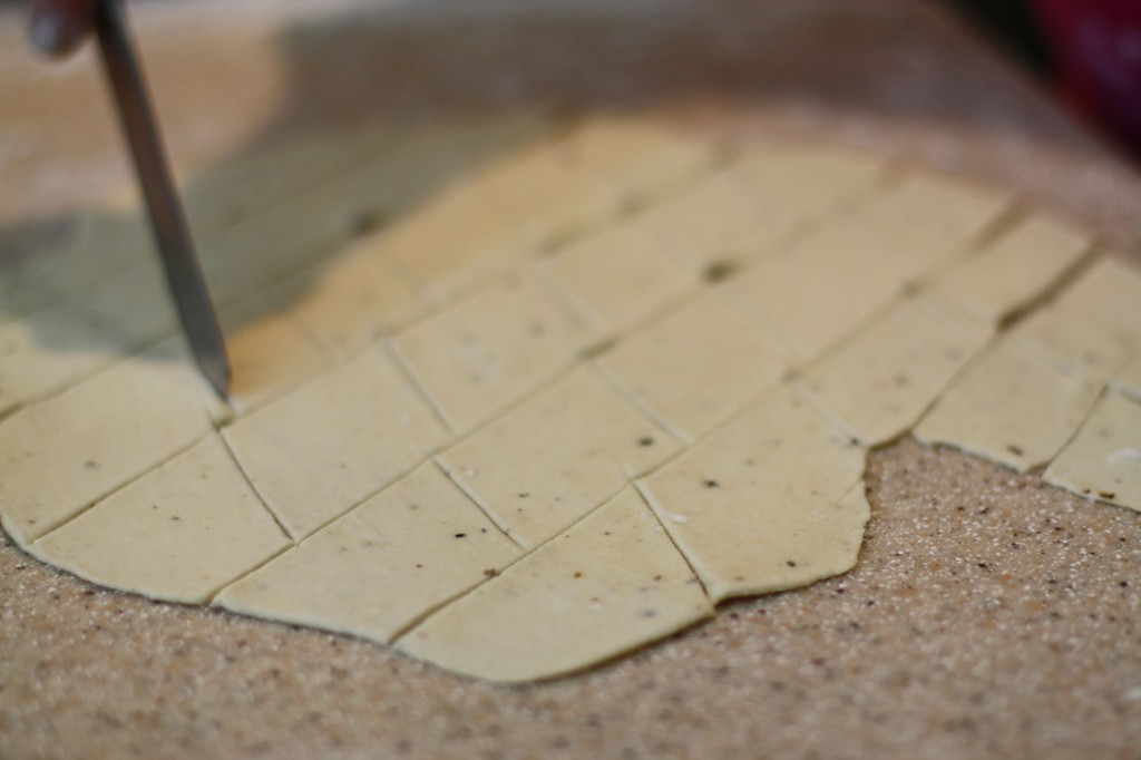 Jill cuts the rolled dough into diamond shapes