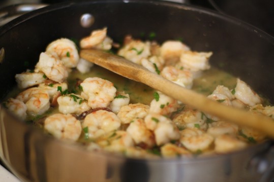 The shrimp are cooked separately and served on top of the grits